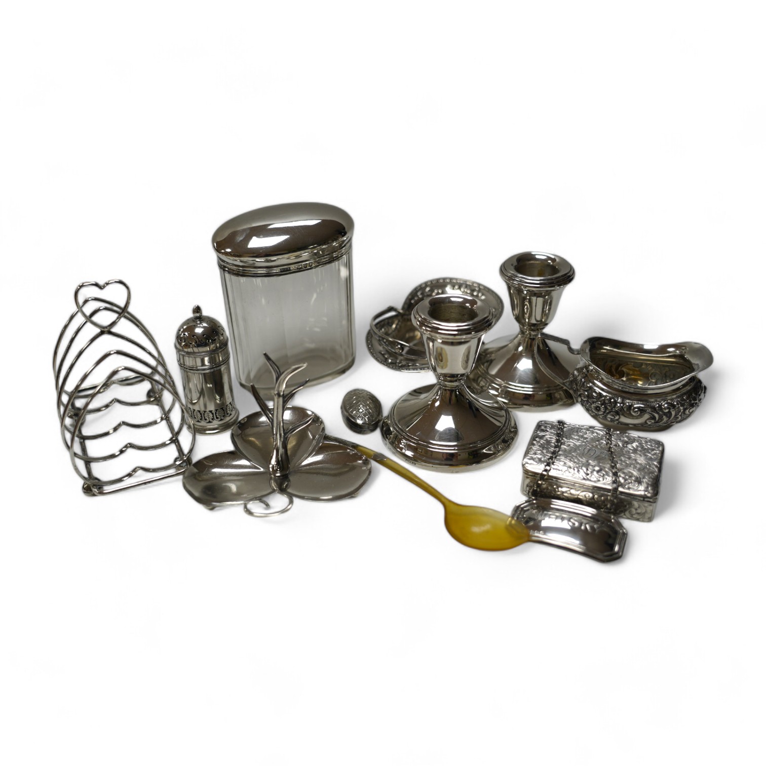 A group of mixed silver including a five bar toastrack, pair of dwarf candlesticks, 19th century snuff box, ring tree dish, cream jug, etc. Condition - poor to fair